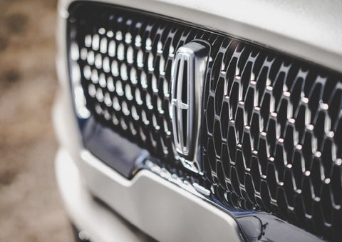 The grille of the 2024 Lincoln Aviator® Reserve model with an eye-catching repeated field of Lincoln Star logo shapes | Libertyville Lincoln Sales, Inc. in Libertyville IL