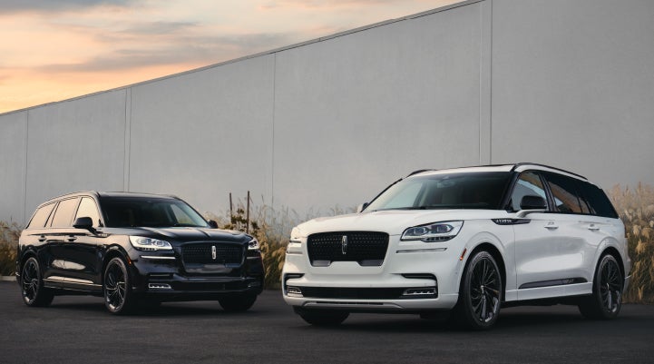 Two Lincoln Aviator® SUVs are shown with the available Jet Appearance Package | Libertyville Lincoln Sales, Inc. in Libertyville IL