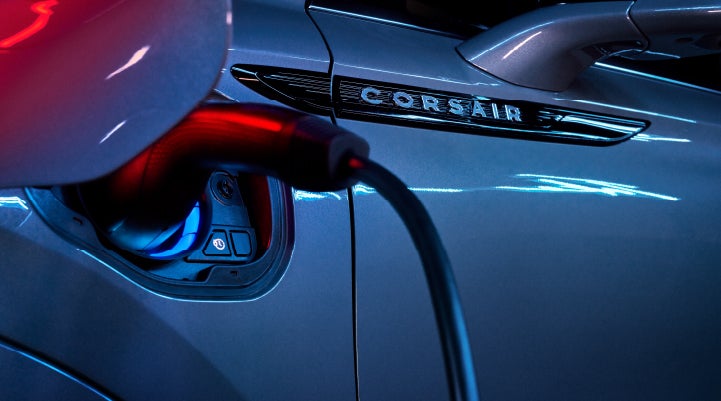 A charger plugged into the charging port of a 2024 Lincoln Corsair® Plug-in Hybrid model. | Libertyville Lincoln Sales, Inc. in Libertyville IL